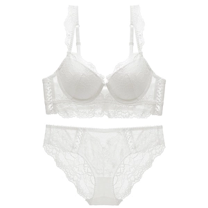 Elegant white lace lingerie set with push-up bra and matching panties on white background