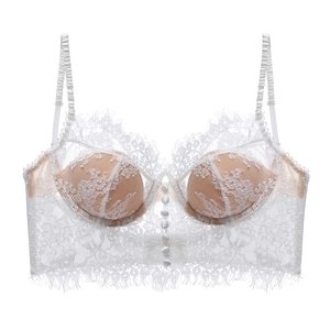Detail of white lace bustier showing floral patterns and delicate fabric buttons