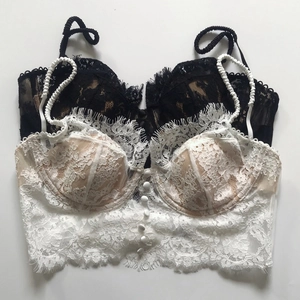 Detailed macro view of delicate floral eyelash lace fabric and textured straps on the bustier