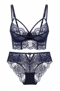 Detail of navy blue longline lace bra with floral patterns and cross-strap accents
