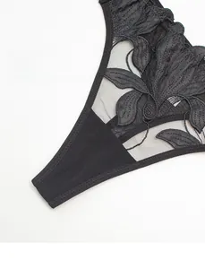 Close-up of black lace floral embroidery and mesh fabric with leg-lengthening narrow side