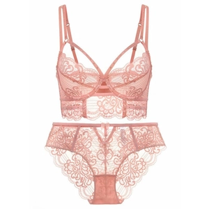 Elegant pink floral lace lingerie set with cross straps and metallic dot accents