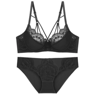 Detailed view of black lace lingerie set with thin cross straps and embroidery