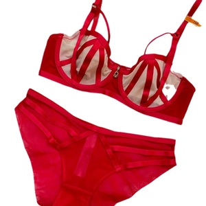 Sexy red French lace lingerie set with stripe mesh bra and strappy panties flat lay