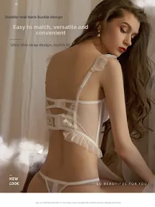 Detail view of white lace lingerie set featuring polka dot mesh and double back closure