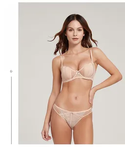 Lace lingerie set with beige semi-cup bra and matching low-waisted briefs on a model