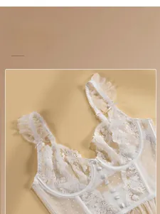 Close-up of white floral embroidery lace with ruffle shoulders and decorative buttons