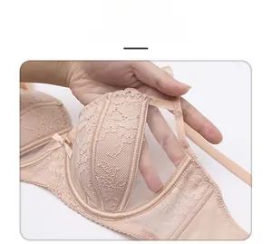 Detail of nude lace mesh bra featuring delicate embroidery and sheer floral fabric textures