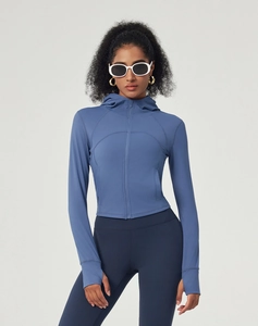 Detail of the gray-blue hooded yoga jacket featuring sleeve thumbholes and zipper closure