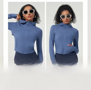 Detail view of a blue hooded yoga jacket featuring a full zipper and hidden side pockets