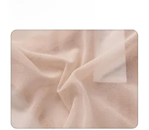 Macro shot of breathable mesh lace fabric showing fine texture and airy structure