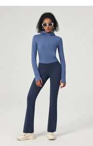 Detail of blue hooded yoga jacket with thumbholes and flared high-waist fitness leggings