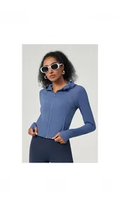 Detail view of blue hooded yoga jacket featuring thumbhole cuffs and slim fit design