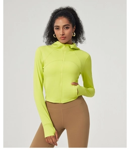 Close-up of neon green yoga jacket featuring thumbhole cuffs and a full zipper design