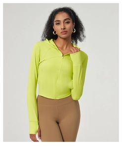 Detail of neon green yoga jacket featuring front zipper and thumbholes for active sports