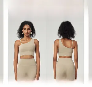 Detailed view of asymmetric sports bra with removable pads and high-waist yoga leggings