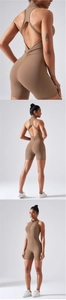 Close-up of cross back design and peach lift detail on mocha yoga romper bodysuit