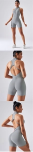 Light gray yoga jumpsuit featuring front zipper, halter neck, and scrunch butt detail