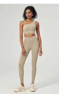 Detail view of asymmetric single shoulder strap and high waist yoga leggings set