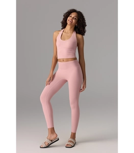 Full body view of pink halter yoga set with high waist leggings and racerback sports top
