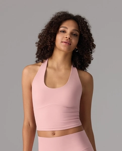 Detailed view of the light pink halter neck yoga top with soft elastic fabric texture
