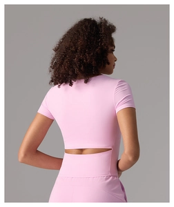 Détail du dos d'un haut de yoga rose à manches courtes avec découpe élégante à la taille