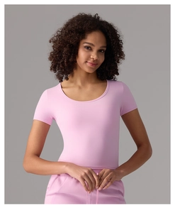 Gros plan du tissu du t-shirt de yoga ajusté et du col rond en rose poudré doux