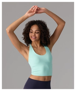Detail of mint green halter yoga top showing the seamless ribbed fabric and slim fit design