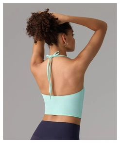 Detail of mint green halter-neck yoga top with backless cut and high-elastic fabric