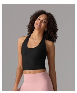Detailed back view of a black halter yoga crop top and pink leggings on a model