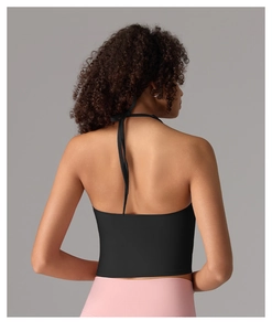Detail of black halter yoga crop top showing backless design and smooth fabric texture