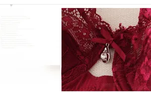 Close-up of wine red lace bra featuring floral patterns with a bow and rhinestone pendant