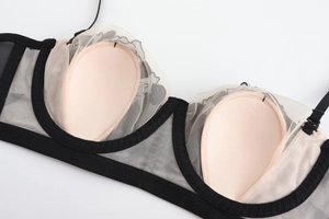 Detail view of lace bra cup interior with breathable mesh lining and support structure