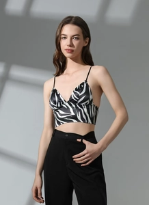 Detail of zebra print satin bralette with thin straps and deep V-neckline for women