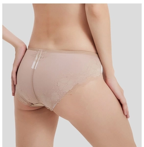 Close-up of beige lace trim and breathable mesh fabric on women's low-rise underwear