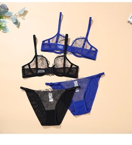 Flat lay of blue and black lace mesh lingerie sets with fine floral embroidery detail
