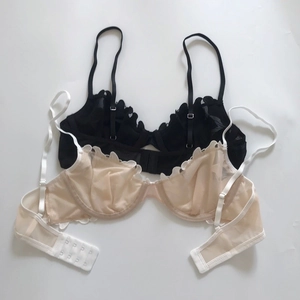 Detailed top view of thin mesh lace bras in black and beige with adjustable straps