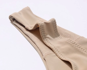 Macro shot of seamless nude bra with reinforced wavy stitching and ribbed fabric detail
