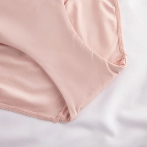 Macro detail of seamless pink knit fabric with reinforced zigzag stitching on underwear