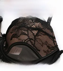 Detail of sheer black lace embroidery and breathable mesh on a feminine bra cup