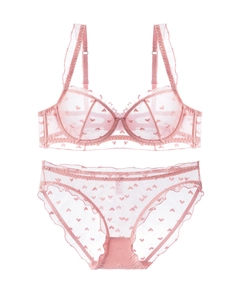 Detail of pink mesh lingerie set with heart patterns and ruffle lace trim