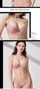 Close-up of pink lace lingerie set with heart embroidery and ruffled mesh details