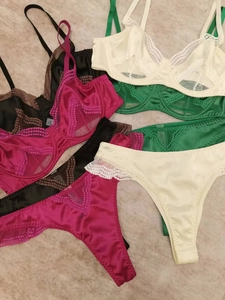 Close-up of assorted lace and satin lingerie sets showing various colors and textures