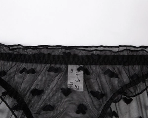 Detail of black mesh lace panties featuring heart-shaped velvet patterns and soft fabric