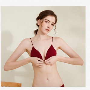 Detailed close-up of dark red seamless triangle bra with front buckle and thin straps