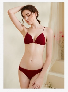Detail of a deep red minimalist seamless bra and panty set with thin straps
