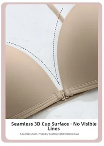 Detail view of seamless beige bra showing the 3D molded cup surface and fabric texture