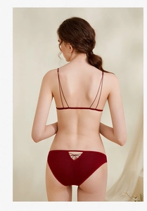 Detail of burgundy lingerie set with thin straps and crisscross lace-up back design