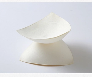 Detail of round triangle bra pad inserts in off-white high density sponge material