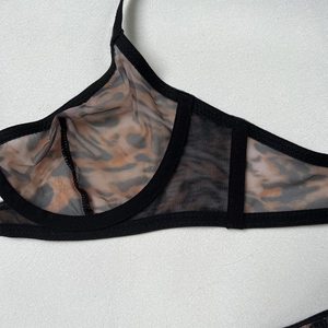 Detail of leopard print mesh bra featuring sheer fabric and delicate black lace trim